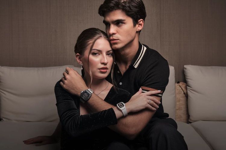 a couple in black clothes wearing the cosmo and the yang regan harney watches 