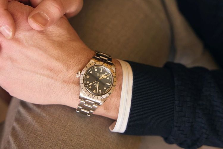 tudor blackbay watch silver black dial worn by a man in suit 